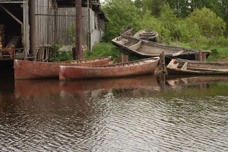 Old fish boats at the shoreの写真素材