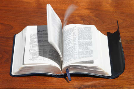 A concept photo of the Holy Spirit turning Bible pages