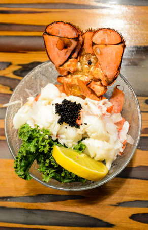 Lobster Sashimi with black tobiko (flying fish roe), lemon and kaleの写真素材