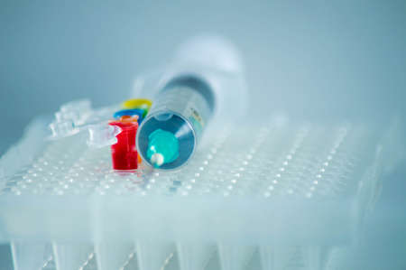 Close-up of a syringe with blue and red liquid.