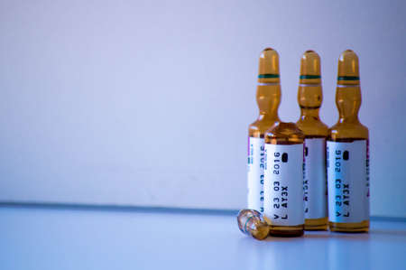 Vaccine vials and syringe on a white background.