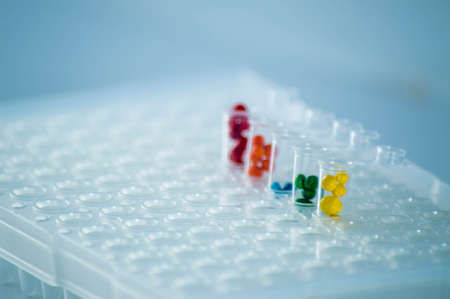 Medical test tubes with multicolored liquids on a white background.の写真素材