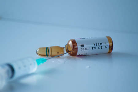 Coronavirus vaccine vial and syringe on white backgroundの写真素材