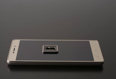 Smartphone with lock, privacy concept, security encryption key. Reliable protection against hacking by hackers.の写真素材