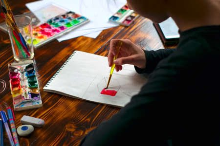 Art. Creature. Close-up. Girl paints watercolor and gouache in the albumの写真素材