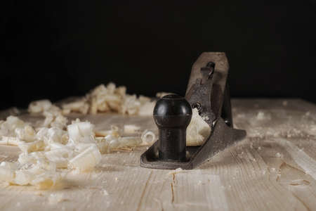 Furniture shield. Planing a wooden furniture panel with a manual planer. Side viewの写真素材