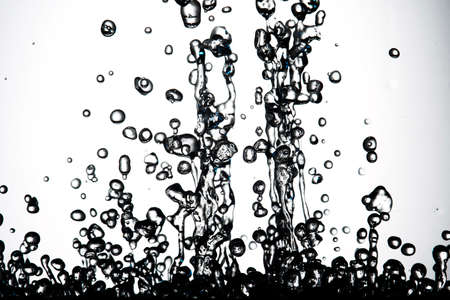 drops of water frozen in flight upwardsの写真素材