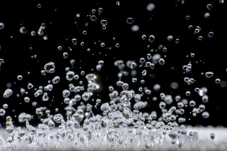 drops of water frozen in flight upwardsの写真素材