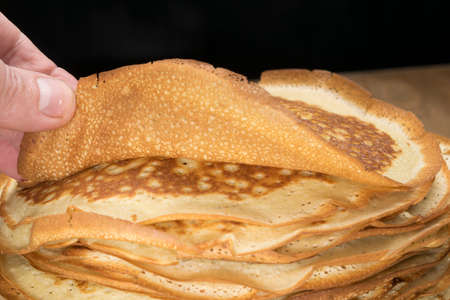 Pancakes in a plate on a wooden table