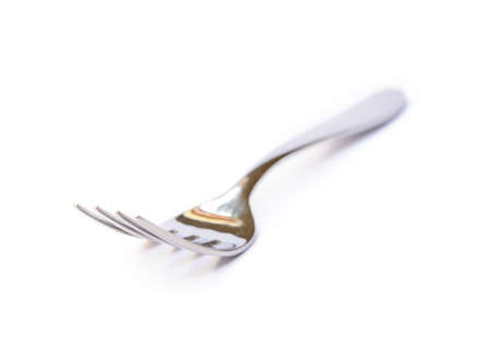 Shiny metal fork on a white backgroundの写真素材
