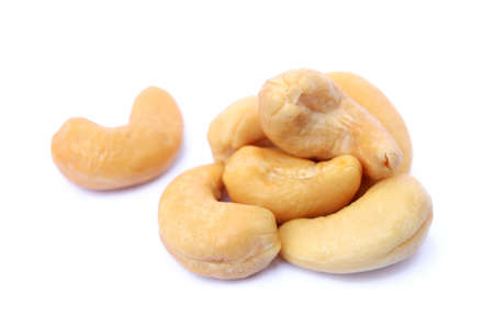 Peeled salted cashews isolated on a white backgroundの写真素材