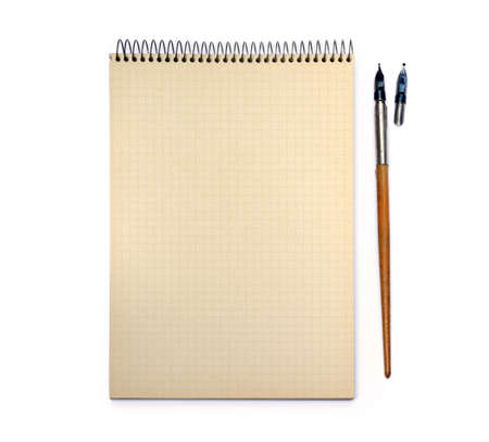 Old ink pen and lined paper isolated on white background