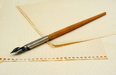 Old ink pen on background with sheets of paperの写真素材
