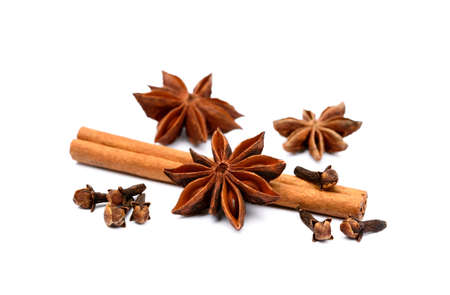Aromatic star anise, cloves and cinnamon isolated on white backgroundの写真素材