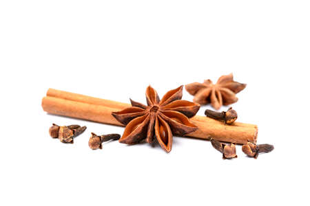 Aromatic star anise, cloves and cinnamon isolated on white backgroundの写真素材