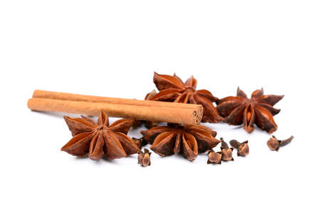 Aromatic star anise, cloves and cinnamon isolated on white backgroundの写真素材