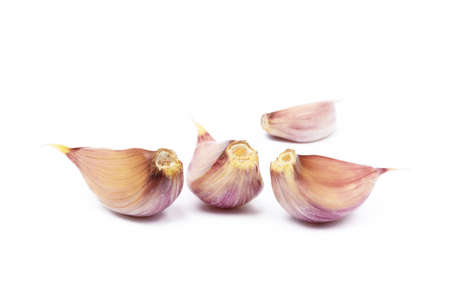 Fresh garlic cloves isolated on white backgroundの写真素材