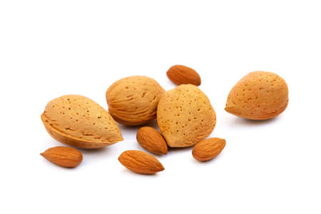 Heap of fresh almonds in shells isolated on white backgroundの写真素材