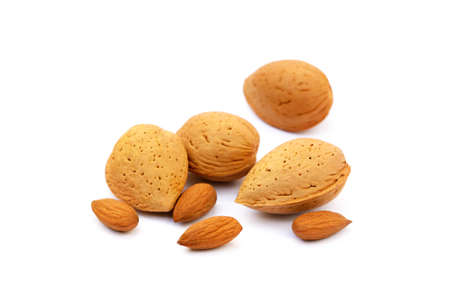 Heap of fresh almonds in shells isolated on white backgroundの写真素材