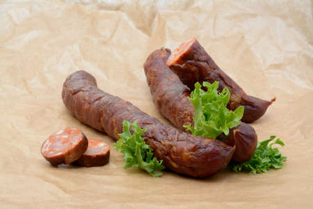Delicious high quality smoked sausage on a crumpled paperの写真素材