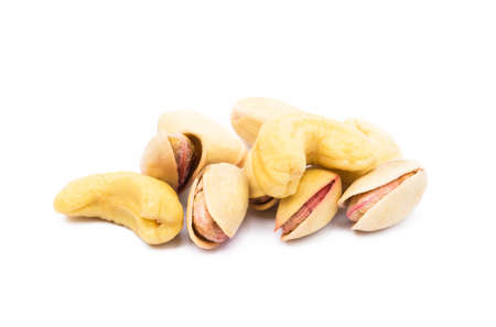 Pile of roasted pistachios and cashew isolated on white backgroundの写真素材
