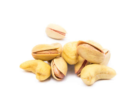 Pile of roasted pistachios and cashew isolated on white backgroundの写真素材