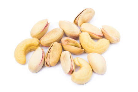 Pile of roasted pistachios and cashew isolated on white backgroundの写真素材