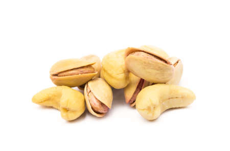 Pile of roasted pistachios and cashew isolated on white backgroundの写真素材