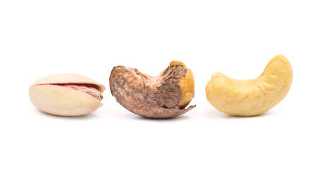 Pile of roasted pistachios and cashew isolated on white backgroundの写真素材