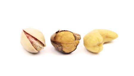 Pile of roasted pistachios and cashew isolated on white backgroundの写真素材
