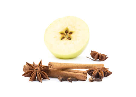 Aromatic apple, star anise, cloves and cinnamon isolated on white backgroundの写真素材