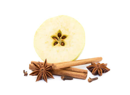 Aromatic apple, star anise, cloves and cinnamon isolated on white backgroundの写真素材