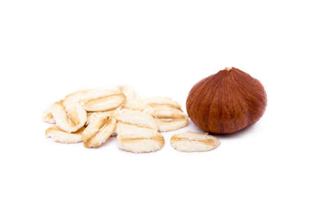 Mix nuts, hazelnut and oatmeal isolated on white backgroundの写真素材