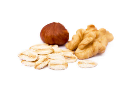 Mix nuts and oatmeal isolated on white backgroundの写真素材