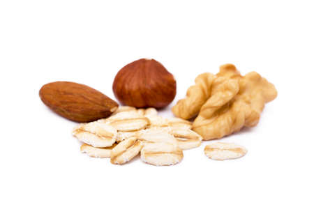 Mix nuts and oatmeal isolated on white backgroundの写真素材