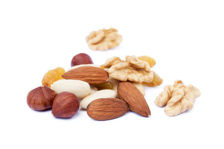 Mixed fresh nuts and raisins isolated on white backgroundの写真素材