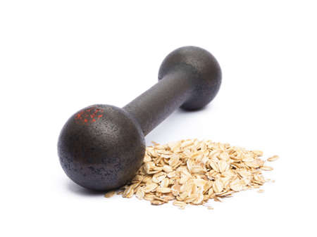 Old gym dumbbells and oat flakes isolated on white backgroundの写真素材