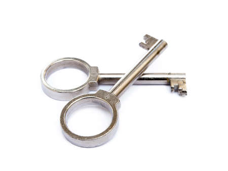 Used door key isolated on white backgroundの写真素材