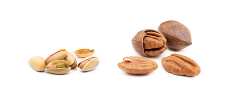 Pile of roasted pistachios and pecan isolated on white backgroundの写真素材
