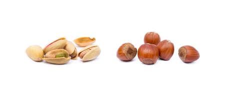 Pile of roasted pistachios and hazelnuts isolated on white backgroundの写真素材