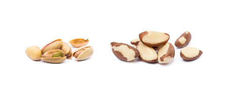 Pile of roasted pistachios and para nuts isolated on white backgroundの写真素材