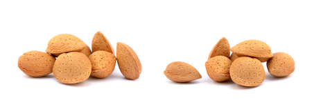 Heap of fresh almonds in shells isolated on white backgroundの写真素材