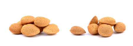 Heap of fresh almonds in shells isolated on white backgroundの写真素材