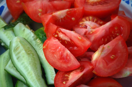 Fresh, juicy, sliced slices ââtomatoes and cucumberの写真素材