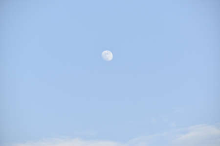 Dramatic view of moon and clouds in the sky.の写真素材
