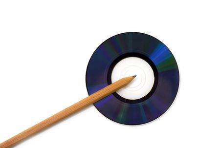 Pencil located next to a computer compact disk, CD.の写真素材