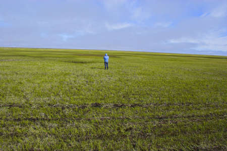 People walking in arctic tundra during summer timeの写真素材