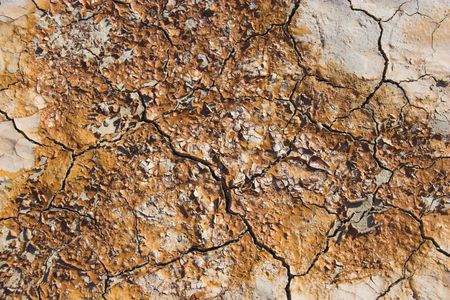 Fragment of  orange clay and salt mineral deposits in geological formations in Ubehebe Volcano, Death Valley National Parkの写真素材
