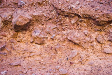 Desert landscape with multicolored red clay and salt mineral deposits in geological formations of Death Valley National Parkの写真素材