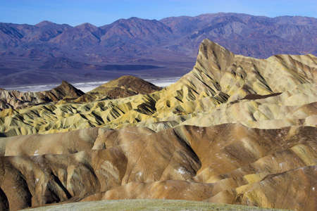 Desert landscape with multicolored yellow clay and salt mineral deposits in geological formations of Death Valley National Parkの写真素材